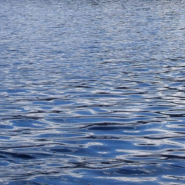 Kwoa photo series - Water close-up - Blue white black reflection over Bled lake gentle waves